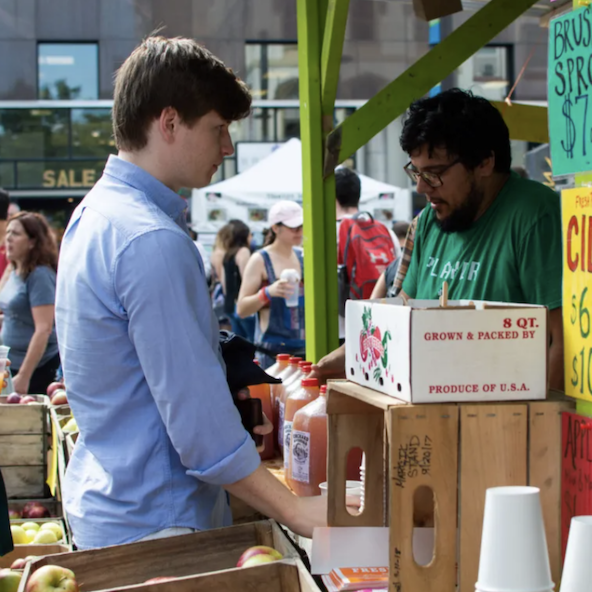 A young man waiting patiently to try some delicious cider!