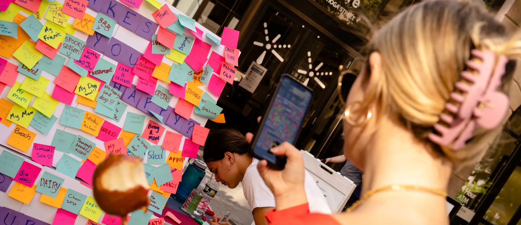 A woman photographing one of the festival's interactive activities!