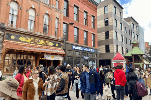 Groups of people shuffling past downtown restaurants and storefronts!